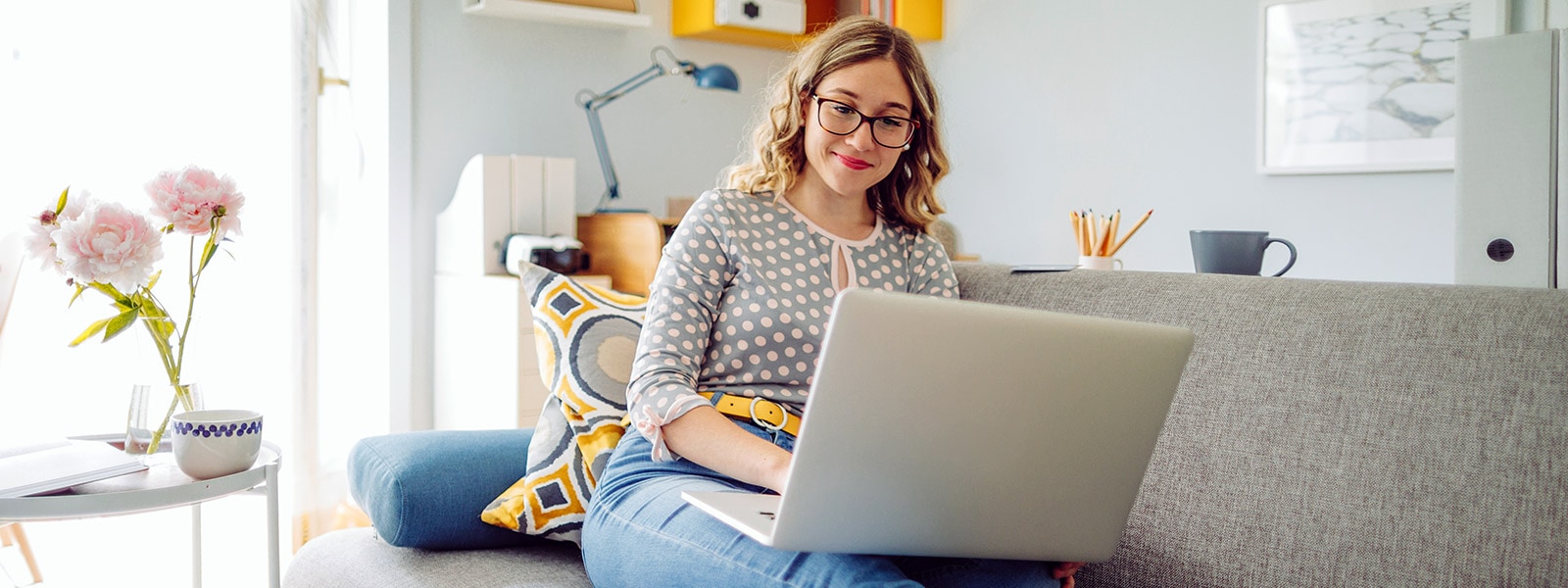 A woman uses her laptop to read about the dark web.