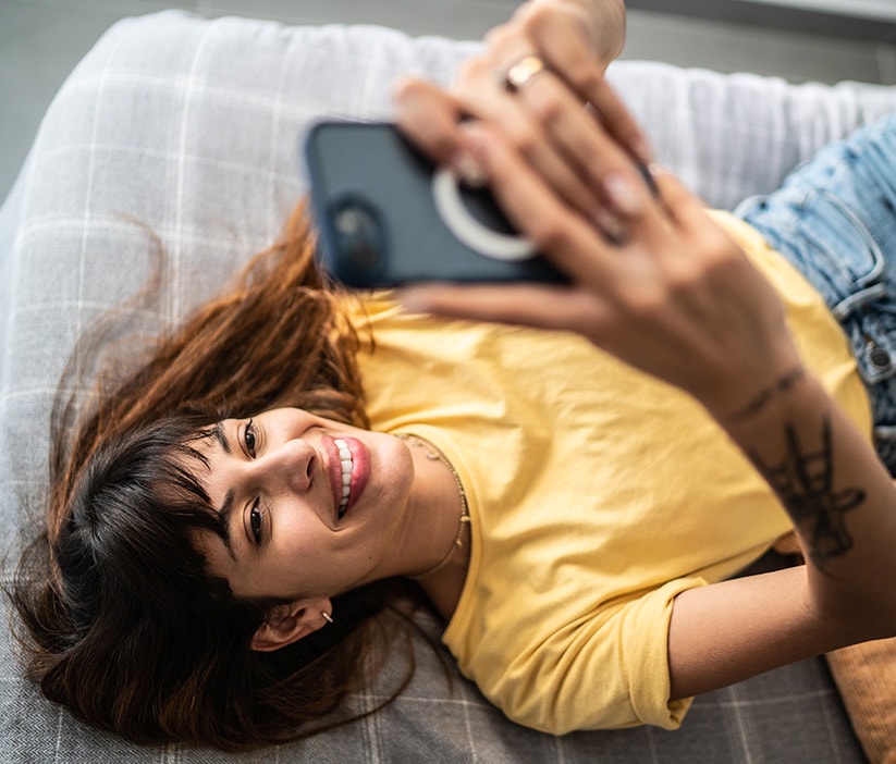 A woman uses her phone to research how to remove personal information from the internet